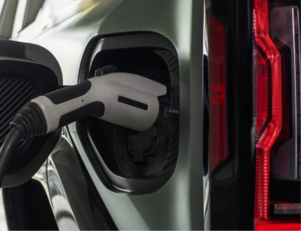 Close up of charging port with charger plugged in on a GMC Hummer EV SUV - Kelley Buick GMC in BARTOW FL