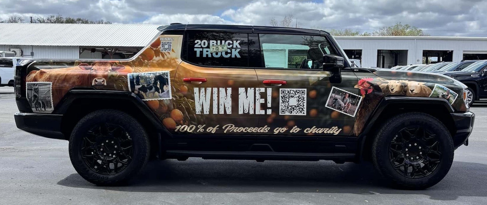 An all-terrain truck or SUV with a colorful wrap featuring farm animals, oranges, 'WIN ME!'' text, and a QR code.